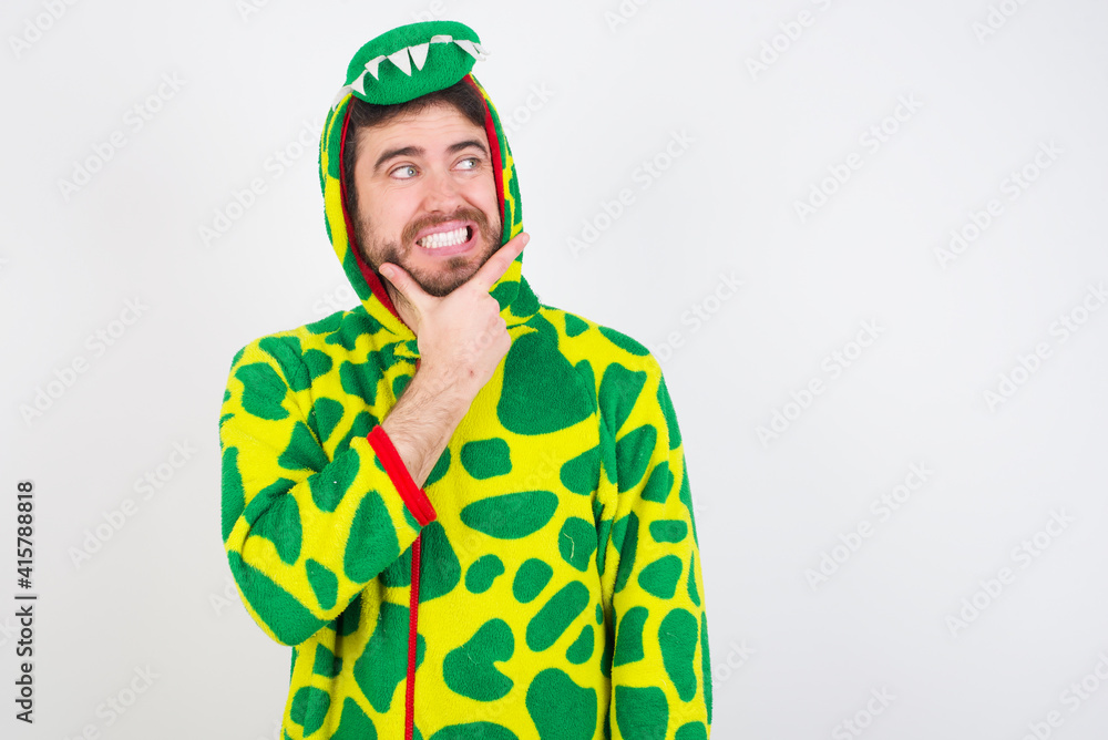 Fototapeta premium young caucasian man wearing a pyjama standing against white wall Thinking worried about a question, concerned and nervous with hand on chin.