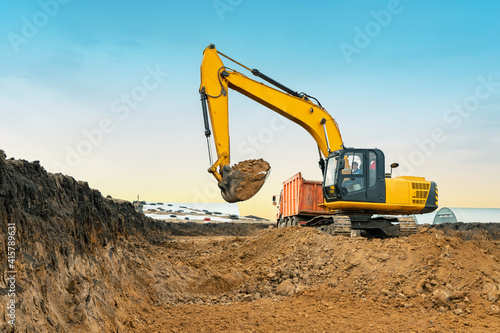 Wallpaper Mural A large construction excavator of yellow color on the construction site in a quarry for quarrying. Industrial image Torontodigital.ca