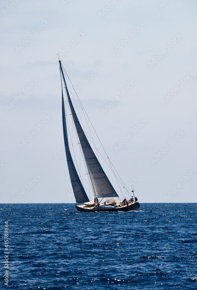 Sailboat sailing in blue sea