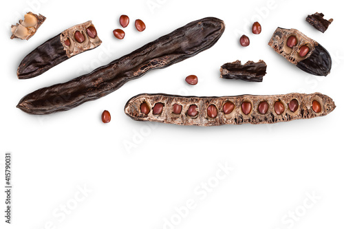 Ripe carob pods and bean isolated on white background with clipping path. Top view with copy space for your text. Flat lay