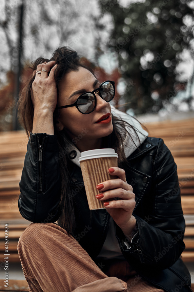 Girl on the street with a disposable paper cup. Take away food, walk around the city. Girl on the street with a disposable paper cup. Take away food, walk around the city.