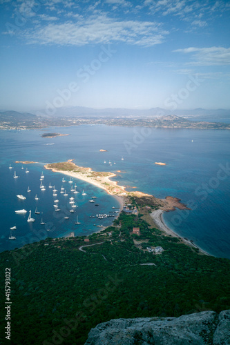Magnificent sea on Sardinia, Italy. Aerial view of boats and yachts moored at sandy shore from lookout. Summer vacation concept.