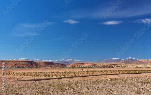 View of the green plain and snowy Atlas Mountains