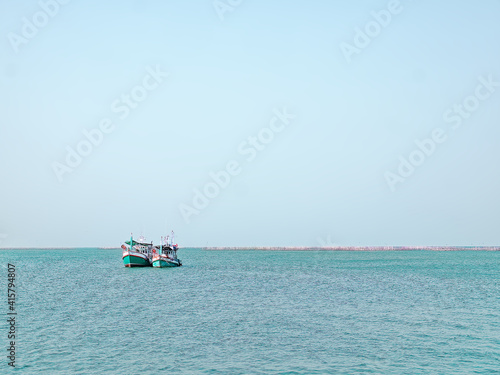 Tranquil Scenery of Two Fisherman Ships in the Sea with Horizon