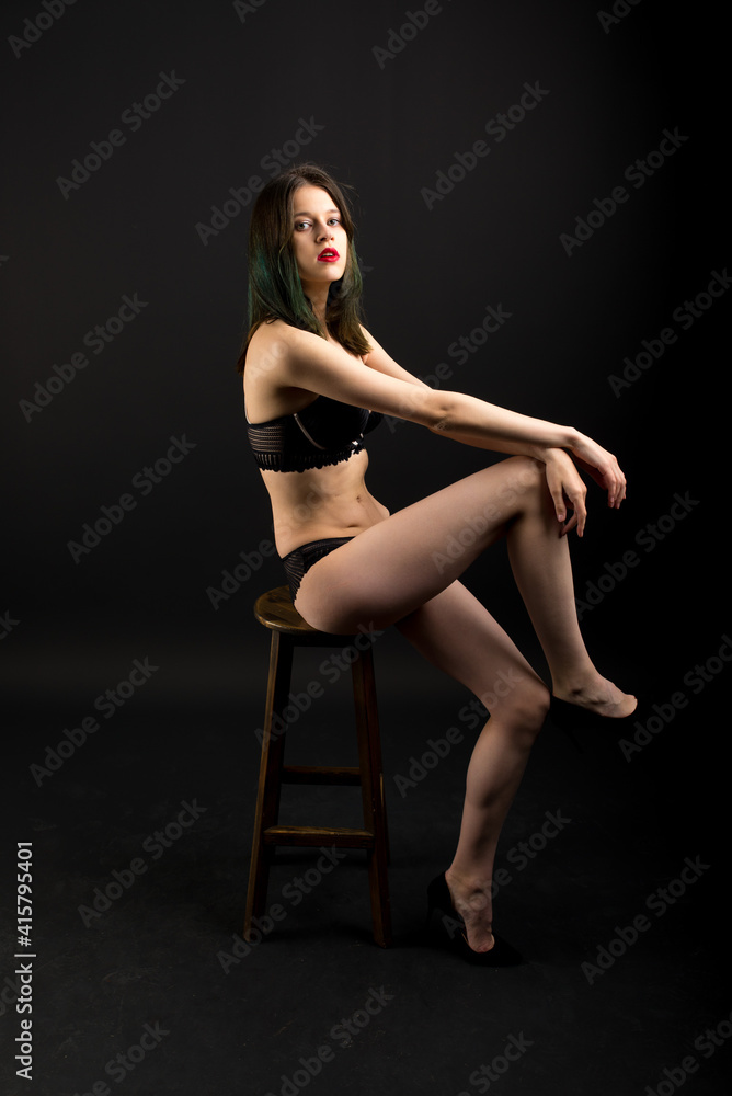 Appealing female model with seductive figure and brunette haircut in the black lingerie Appealing female model with seductive figure and brunette haircut in the black lingerie