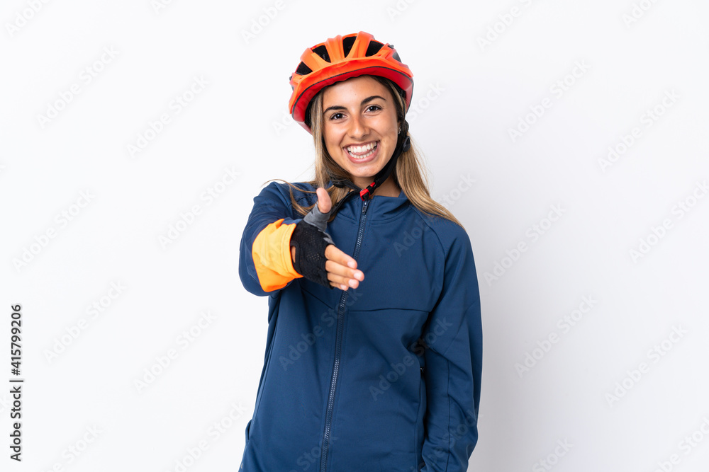 Young hispanic cyclist woman isolated on white background shaking hands for closing a good deal Young hispanic cyclist woman isolated on white background shaking hands for closing a good deal
