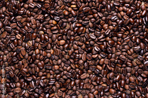 Roasted Ccoffee beans background. Arabic roasting coffee. Ingredient of hot beverage.