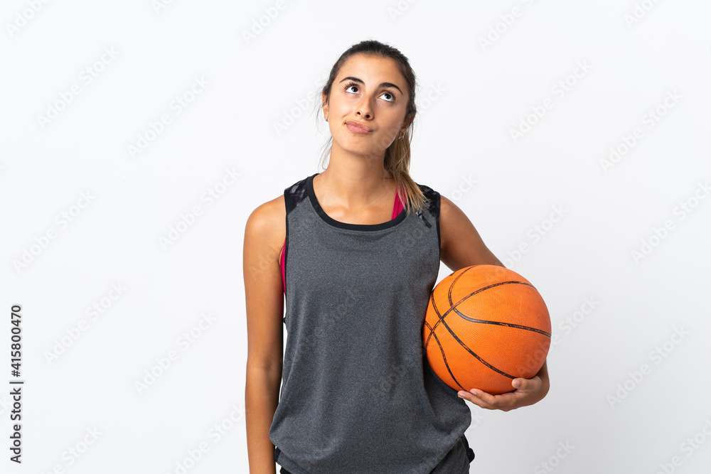 Young hispanic woman playing basketball over isolated white background and looking up Young hispanic woman playing basketball over isolated white background and looking up