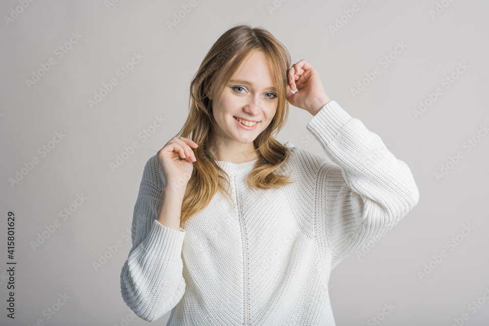 Portrait of a stylish and smiling girl on a white background in the studio Portrait of a stylish and smiling girl on a white background in the studio