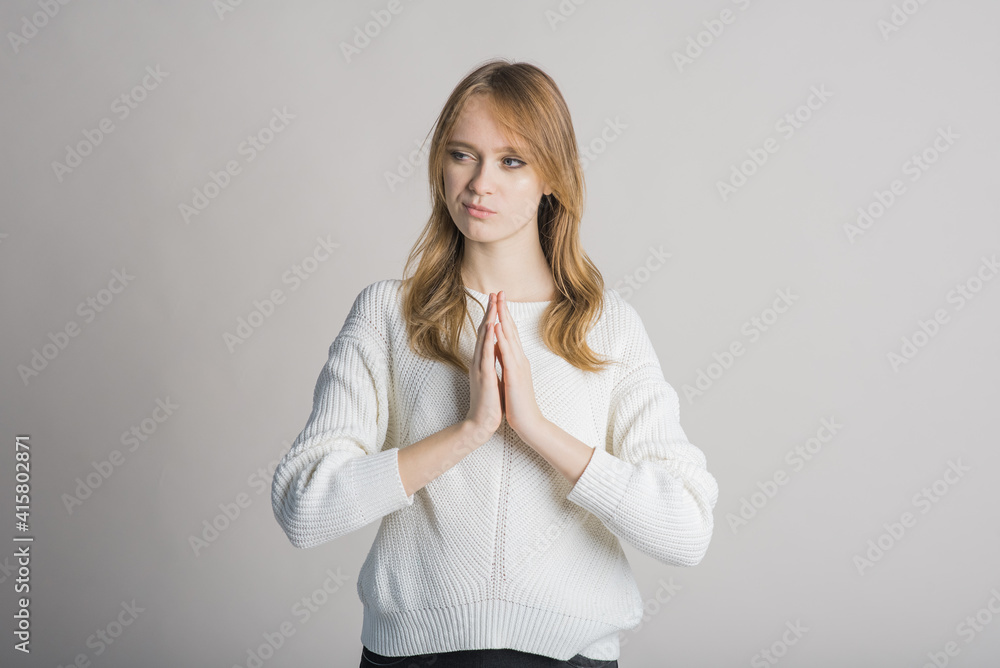 Portrait of a beautiful girl on a white background in the studio who has an idea Portrait of a beautiful girl on a white background in the studio who has an idea