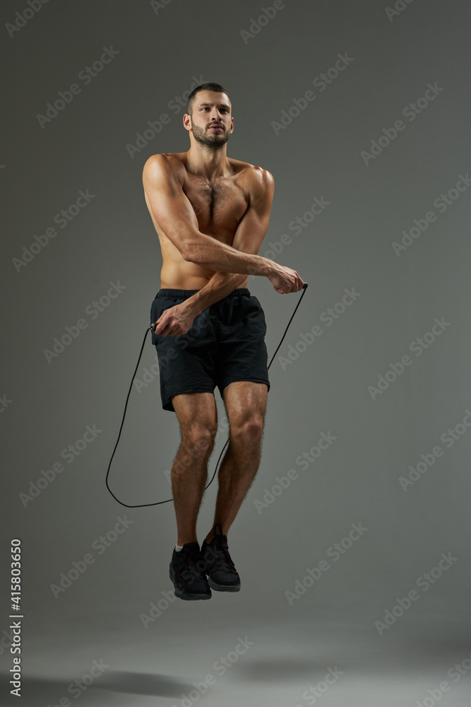 Fototapeta premium Focused athlete getting in shape isolated on grey background in the studio