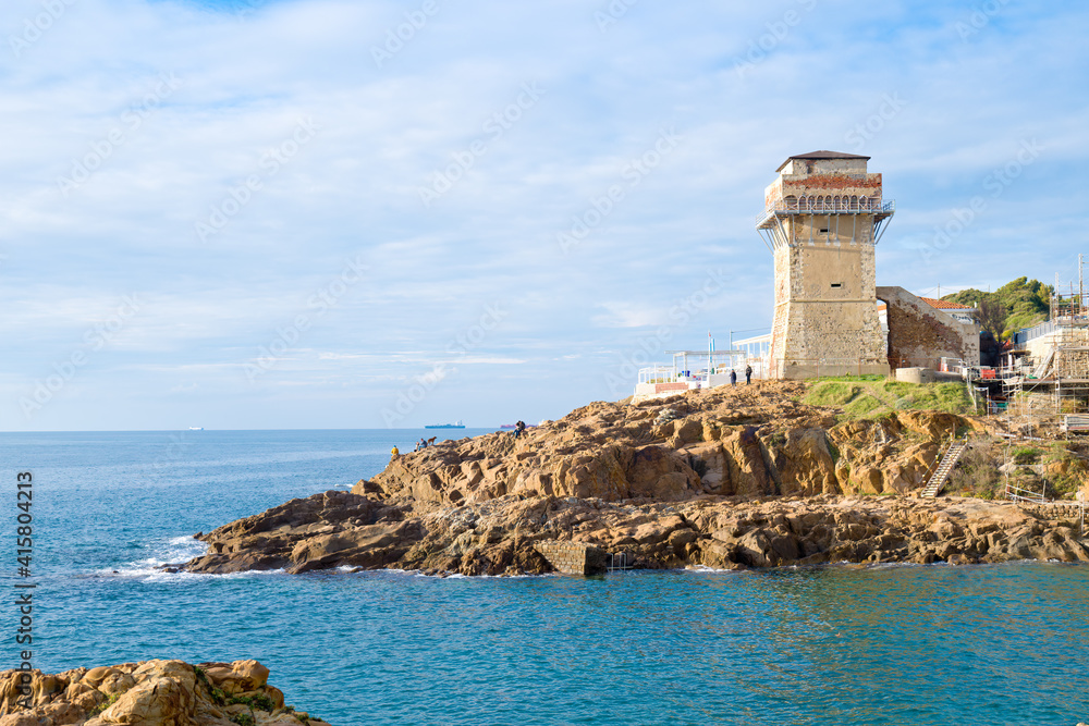 Livorno, Tuscany, Italy: Beach and cliffs of calafuria. The tower indicates the cliff under the Aurelia bridge: a beautiful sea, a classic diving destination.