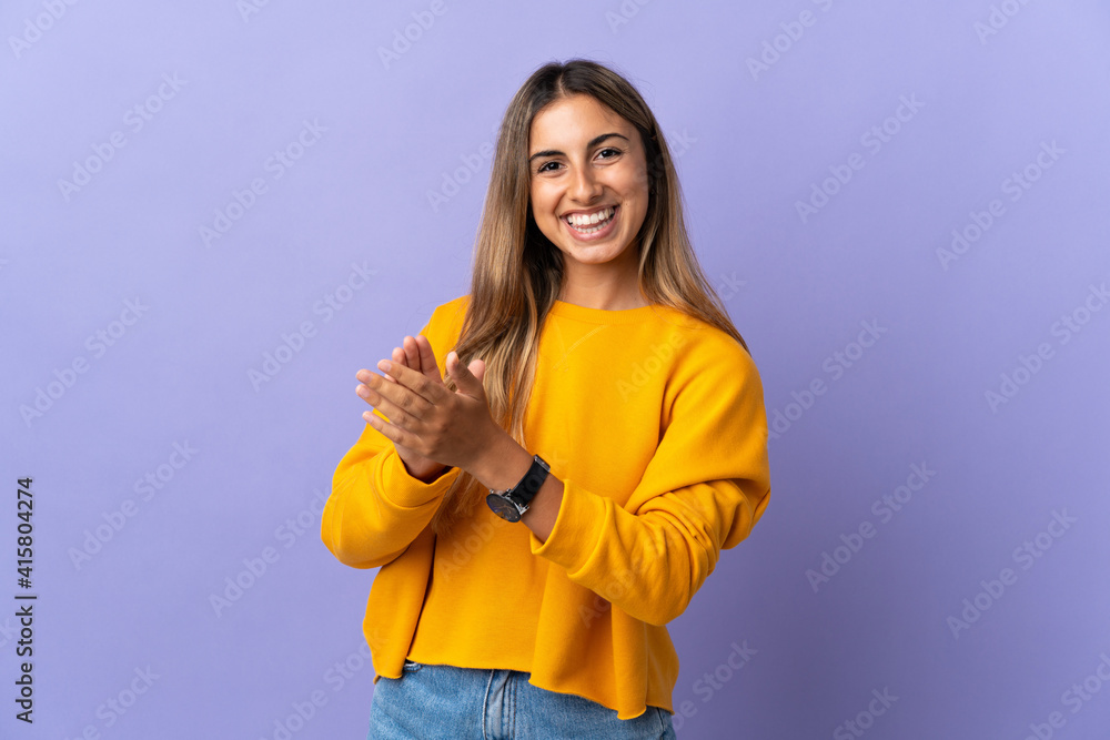 Young hispanic woman over isolated purple background applauding after presentation in a conference Young hispanic woman over isolated purple background applauding after presentation in a conference