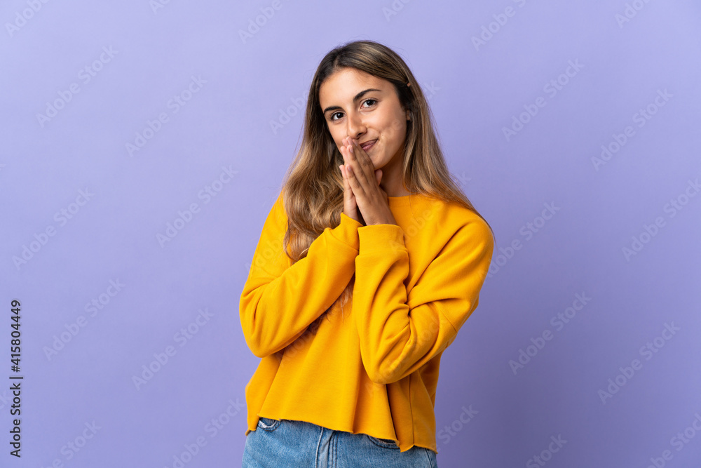 Young hispanic woman over isolated purple background keeps palm together. Person asks for something Young hispanic woman over isolated purple background keeps palm together. Person asks for something