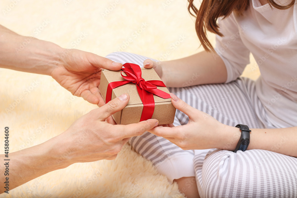 Man gives a present to woman Man gives a present to woman