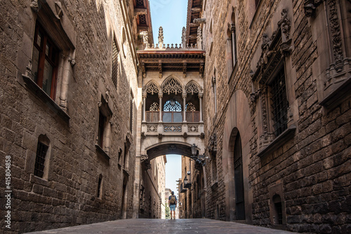 A male traveler with a backpack visiting the Gothic quarter of the city of Barcelona, Spain 