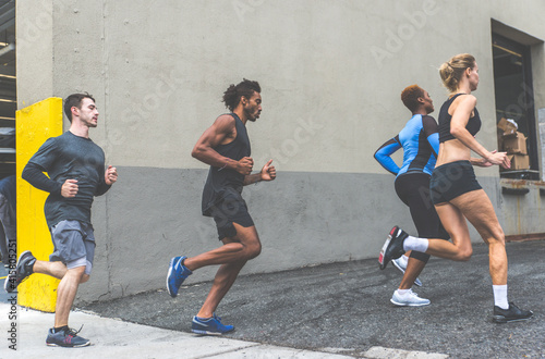 Group of urban runners running on the street in New york city, conceptual series about sport and fitness