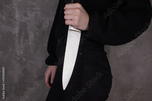 Woman hand holding big knife. Aggressive woman.