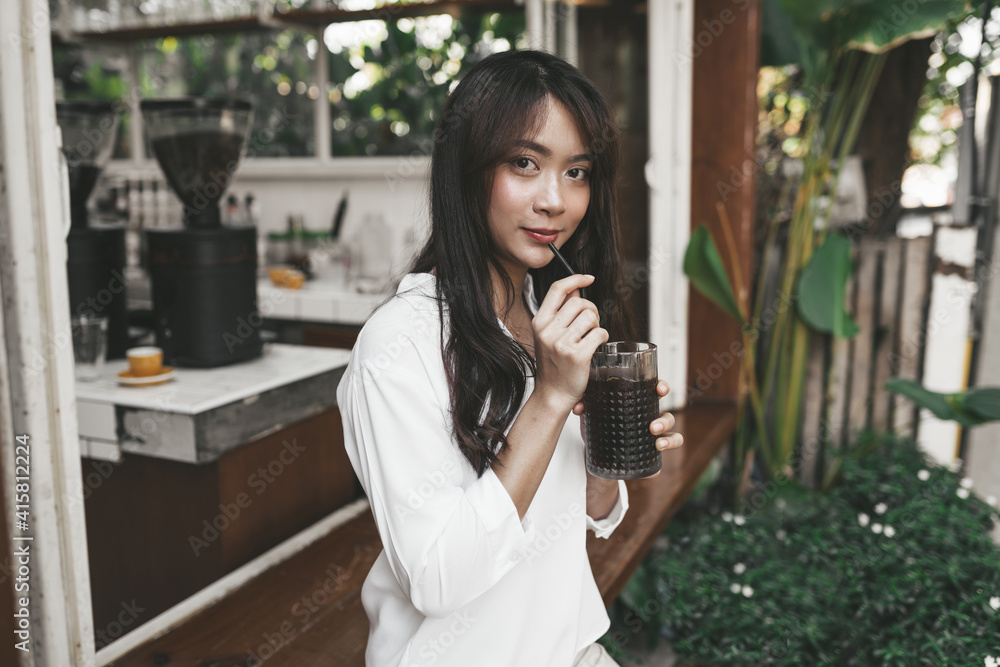 Cute asian young woman sitting in cafe with coffee Cute asian young woman sitting in cafe with coffee