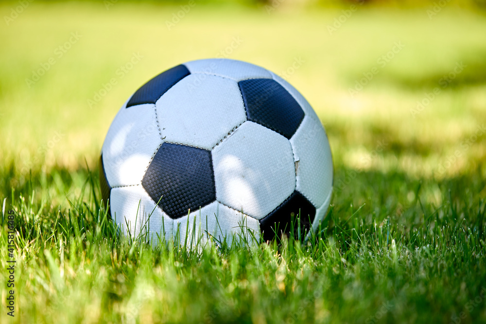 close-up view of leather soccer ball on green grass close-up view of leather soccer ball on green grass