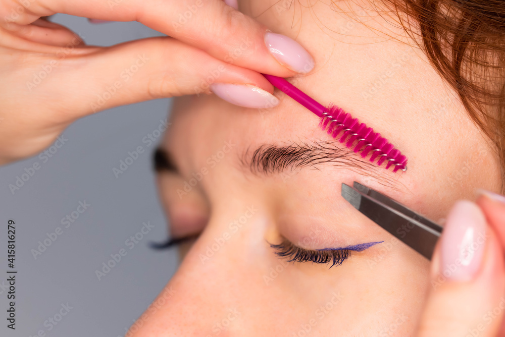 Young Caucasian Woman on the brow beauty procedures. Professional care for face. Brows coloring, wax and lamination. 