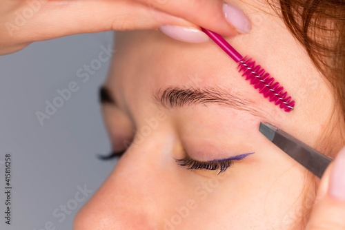 Young Caucasian Woman on the brow beauty procedures. Professional care for face. Brows coloring, wax and lamination.  © strigana