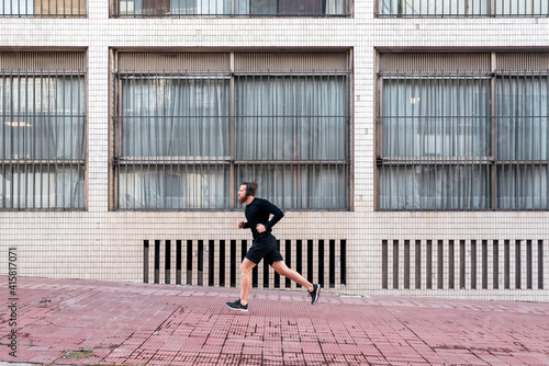 Young Man Running in the Street