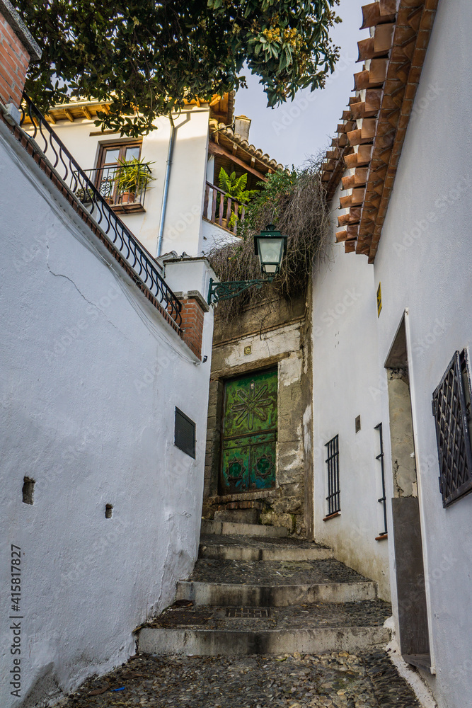 the narrow streets and white facades typical of the Albaicin historic district in Granada, Andalusia, Spain