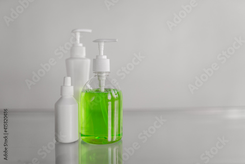 Three tubes with liquid antibacterial soap on the table on a white background. High quality photo