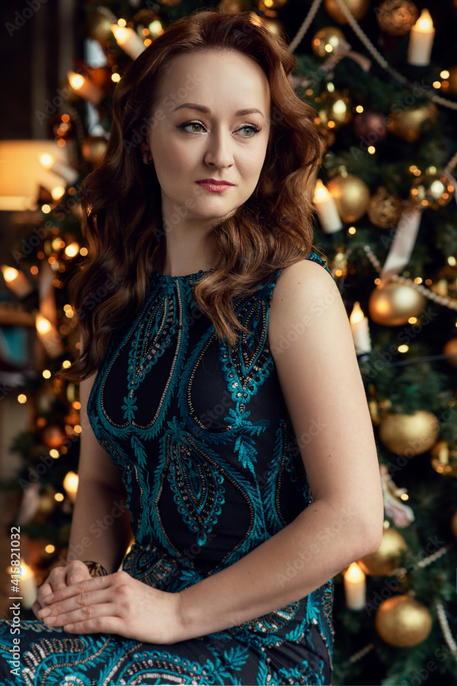 Red-haired girl in the background of the Christmas tree in retro style Red-haired girl in the background of the Christmas tree in retro style