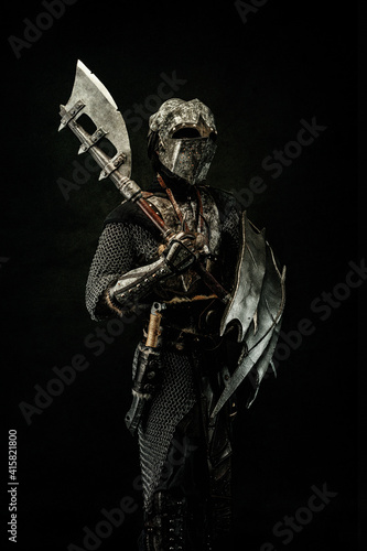 Tableau sur toile Medieval fighter in armor, carrying a shield and an ax on his shoulder
