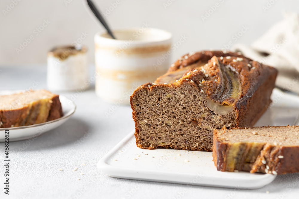 vegan buckwheat banana bread with dates on cutting board. Gluten free, sugar free vegan food. close-up. blurred background vegan buckwheat banana bread with dates on cutting board. Gluten free, sugar free vegan food. close-up. blurred background