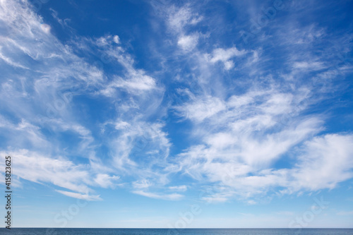 Beautiful sky over the sea with cirrus and small cumulus clouds