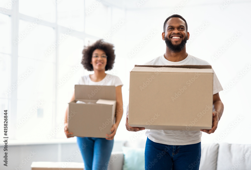 African American Couple Moving Carrying Cardboard Boxes Entering Own House African American Couple Moving Carrying Cardboard Boxes Entering Own House