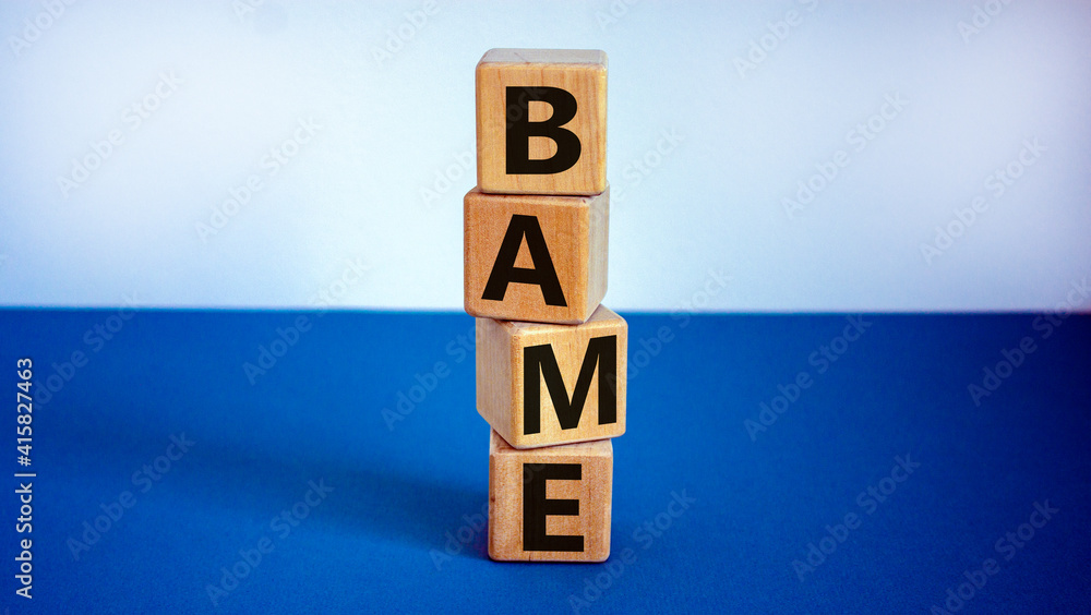 BAME symbol. Abbreviation BAME, black, asian and minority ethnic on wooden cubes. Beautiful white and blue background. Copy space. Business and BAME, black, asian and minority ethnic concept. BAME symbol. Abbreviation BAME, black, asian and minority ethnic on wooden cubes. Beautiful white and blue background. Copy space. Business and BAME, black, asian and minority ethnic concept.