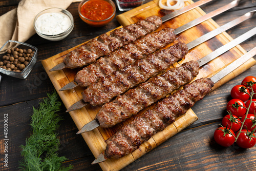 lula kebab with vegetables on cutting board