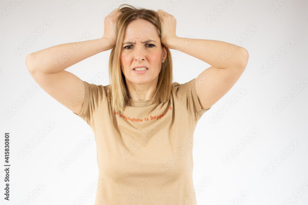 Portrait of young annoyed woman in casual t-shirt with collar pulling her hairs and getting crazy Portrait of young annoyed woman in casual t-shirt with collar pulling her hairs and getting crazy