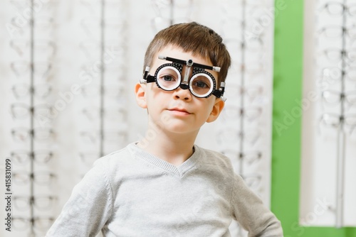 Trial frame. Glasses for a little boy. Hypermetropia. Ametropia correction with glasses. photo