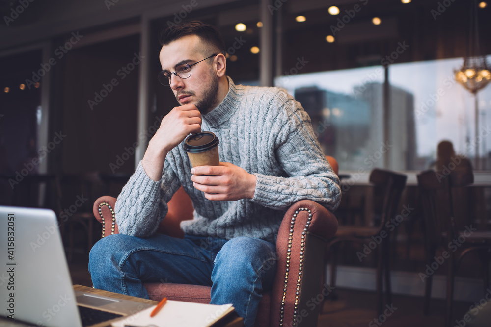 Thoughtful businessman sitting in cafeteria Thoughtful businessman sitting in cafeteria