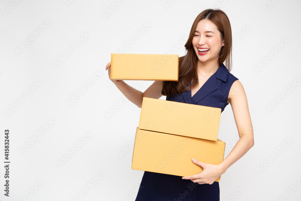 Happy Asian woman smiling and holding package parcel box isolated on white background, Delivery courier and shipping service concept Happy Asian woman smiling and holding package parcel box isolated on white background, Delivery courier and shipping service concept