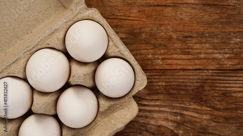 White eggs on wooden background. Easter and healthy food breakfast cooking concept
