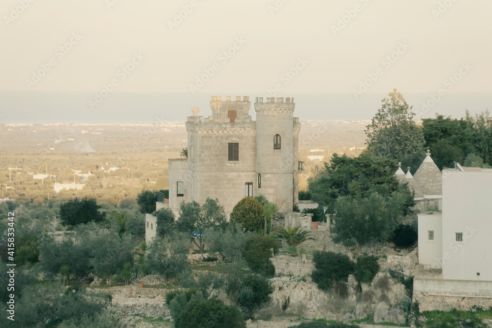 An amazing view of the valley of Ostuni (Apulia, Italy), with an old tower as the main subject. Daylight.
