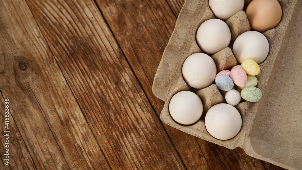 Chicken eggs in a cardboard tray and Easter decor on a wooden background., Rural Style Chicken eggs in a cardboard tray and Easter decor on a wooden background., Rural Style