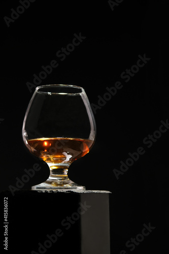 Cognac glass, isolated on a black high background. Cognac.