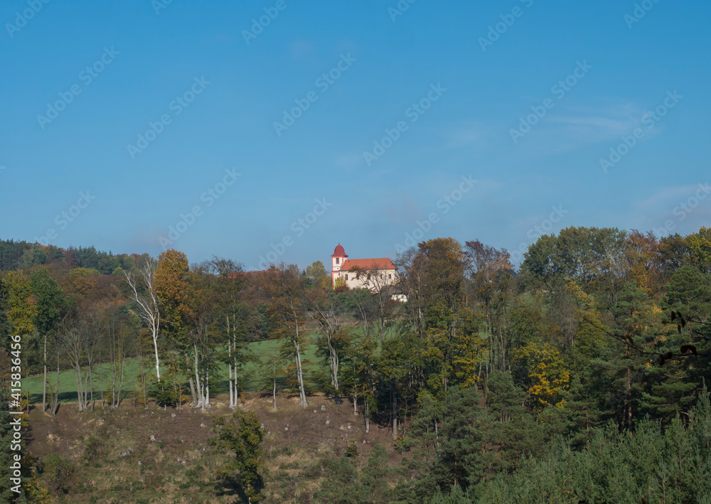 Autumn mixed forest landscape with baroque church of sv. Jakuba, St. Jacob on the hill at village Borejov,Nature park Kokoronsko, Czech republic Autumn mixed forest landscape with baroque church of sv. Jakuba, St. Jacob on the hill at village Borejov,Nature park Kokoronsko, Czech republic