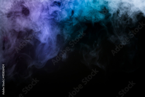 colored pink and blue smoke on black