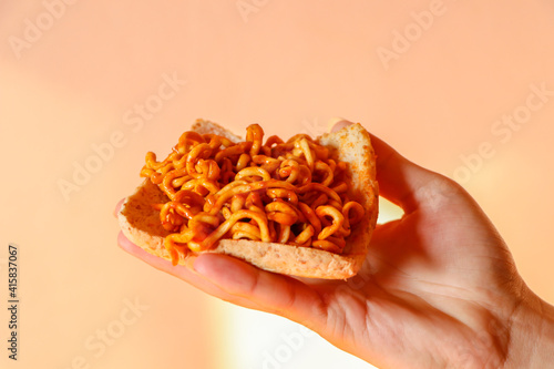 close up of a handful of pasta on a black background
