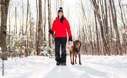 Portrait of a woman with labrador dog in winter season