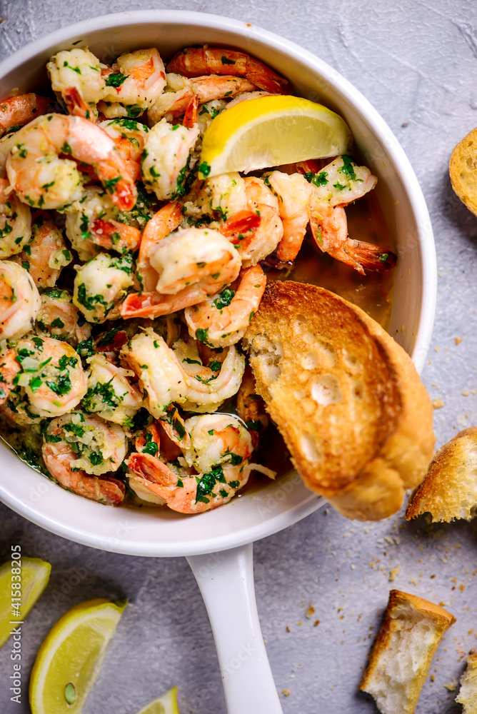 Lemon garlic butter srimp in a white frying pan.top view Lemon garlic butter srimp in a white frying pan.top view