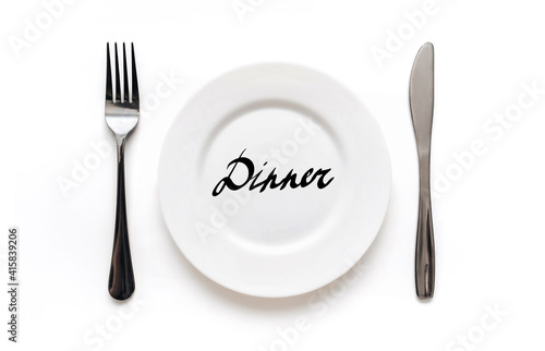 A white plate on which the word Diet is written standing on a tablecloth . The concept of a balanced diet, ration and medical fasting. Top view, white background, copy space.